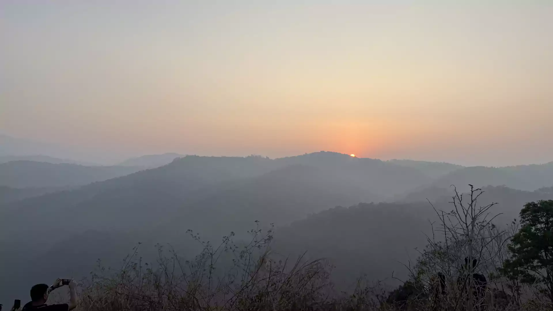 Golden sunrise over the misty hills of Munnar as seen from Sceva's Garden Home, where guests wake up to peaceful mountain views, fresh air, and birdsong.