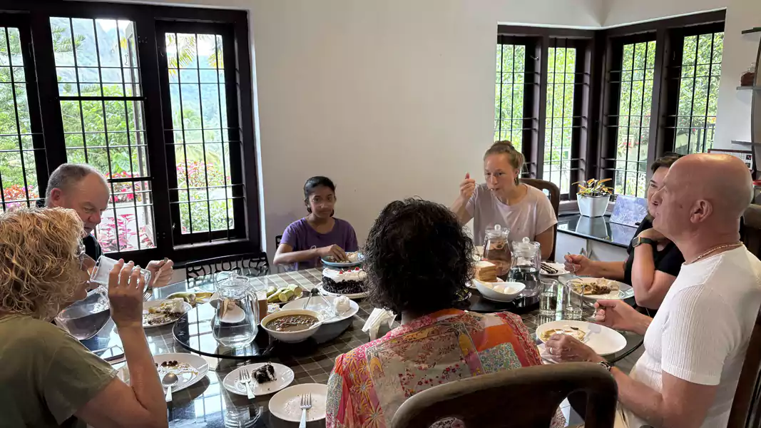 Sheeja serving a freshly prepared home-cooked Kerala breakfast to guests at Sceva's Garden Home, where direct bookings include personalised family hospitality near Munnar.