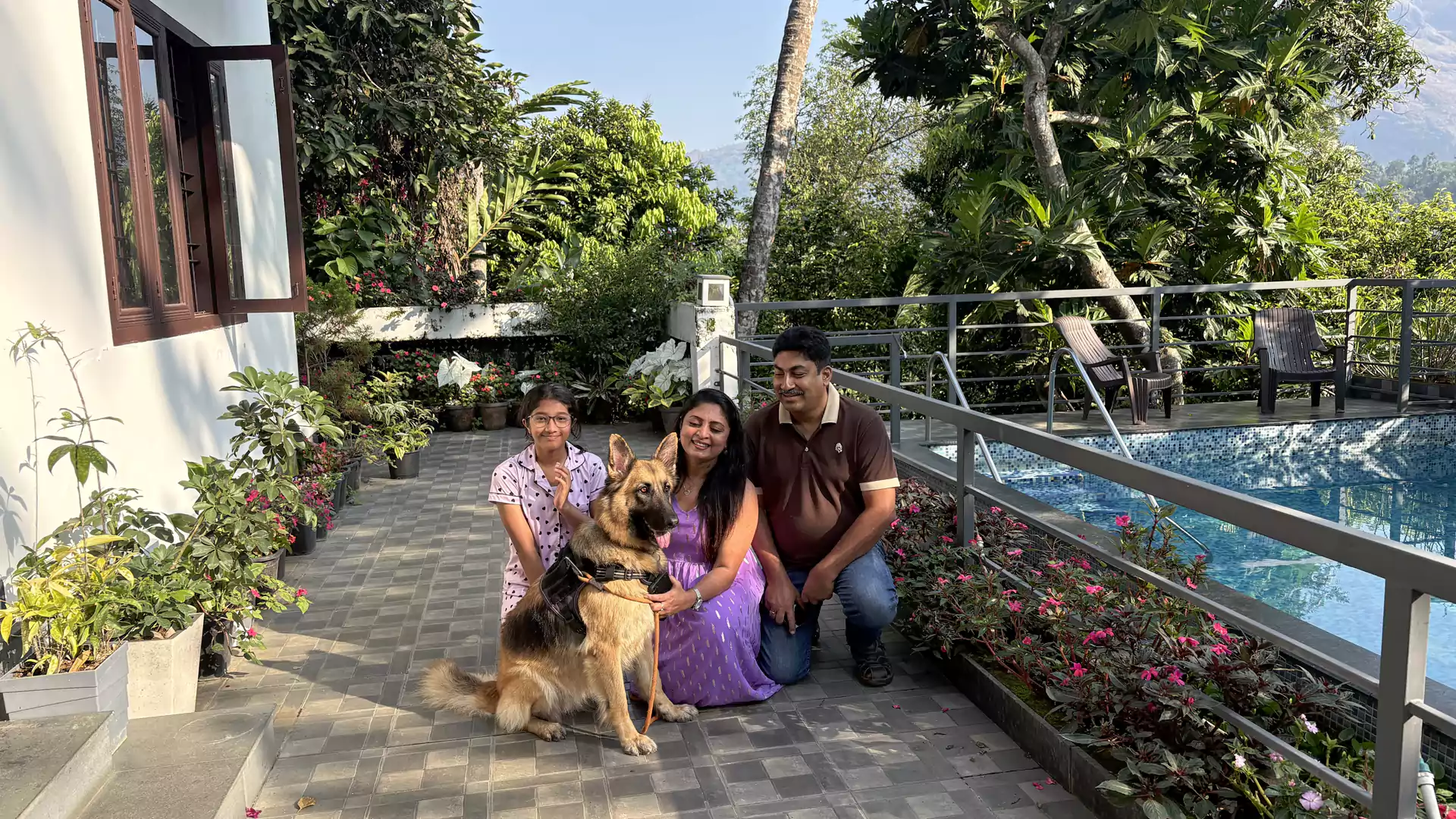 Sceva welcoming guests and their pet at Sceva's Garden Home, a family-run pet-friendly homestay in Munnar where every member of the family, including four-legged companions, is warmly welcomed.