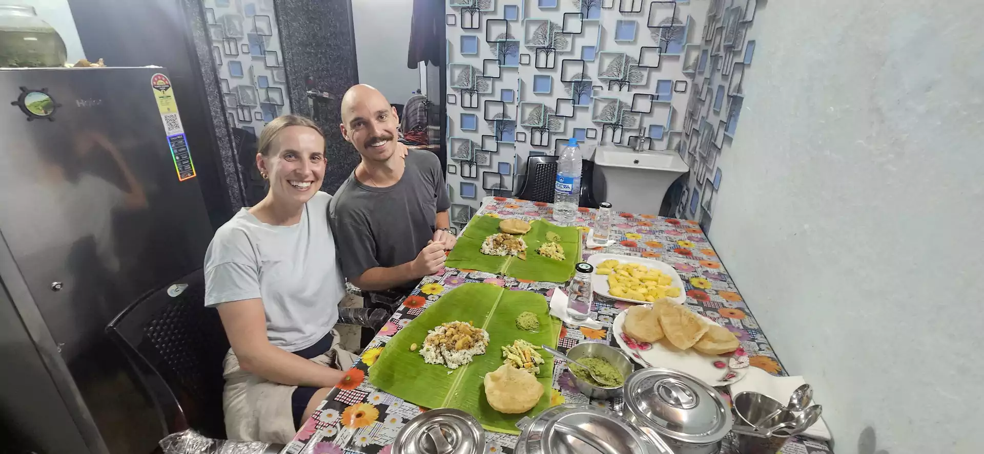 Guests enjoying an authentic home-cooked Kerala meal after a village cooking class and guided trekking experience in Munnar.