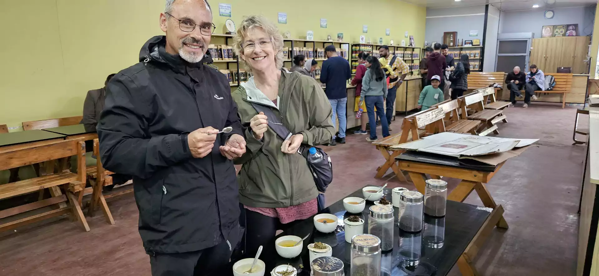 Guests enjoying a tea tasting experience during a guided visit to a traditional tea factory in Munnar, sampling freshly brewed Kerala tea.